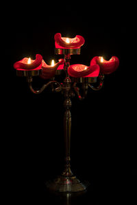 Close-up of illuminated lamp against black background