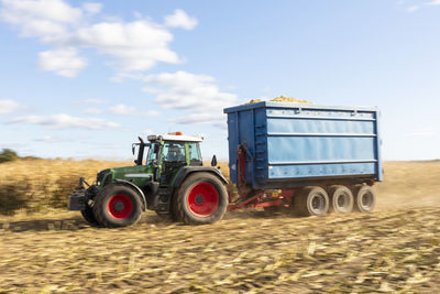 Tractor with trailer on field