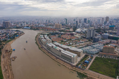 High angle view of illuminated city buildings against sky