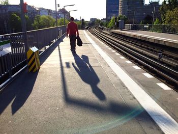 Shadow of man on road