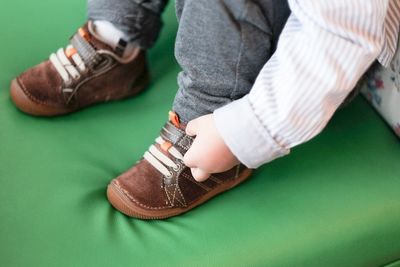 Low section of man wearing shoes
