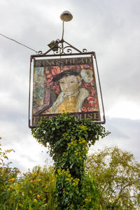 Low angle view of information sign against sky