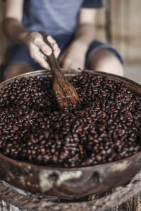 Close-up of hand holding coffee beans