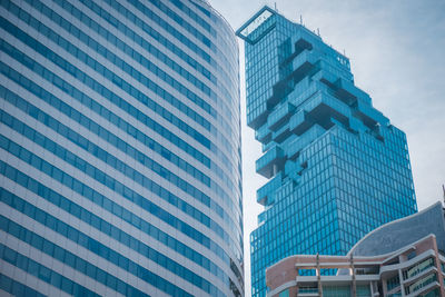 Low angle view of modern building against blue sky