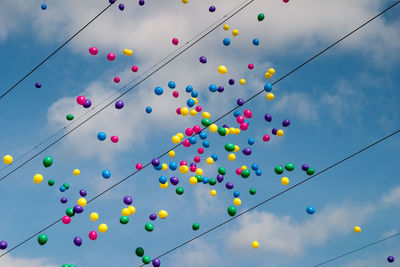 Low angle view of balloons against sky