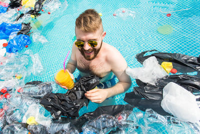 Portrait of man swimming in pool