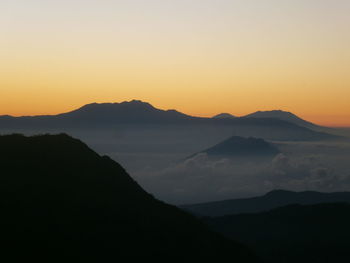 Scenic view of silhouette mountains against sky during sunset