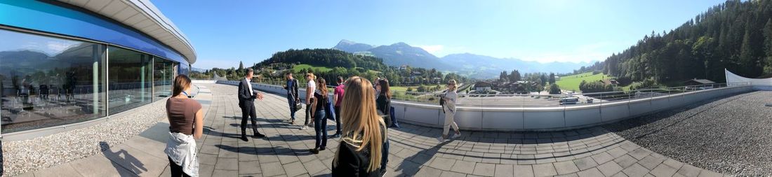 Panoramic view of people on mountain against sky