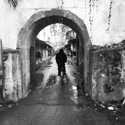 Full length of people walking in tunnel