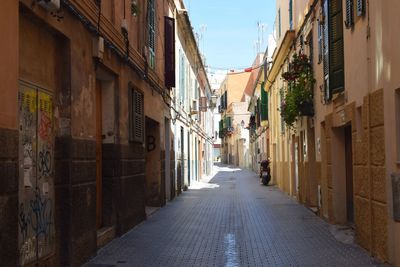 Narrow alley along buildings in ibiza 