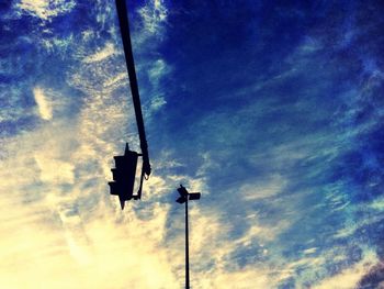 Low angle view of street light against cloudy sky