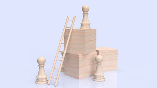 Stack of chess on table against white background