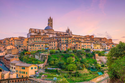 Buildings in city at sunset