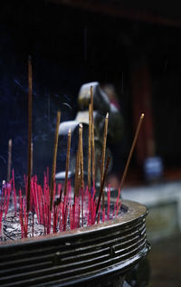 Burning incense sticks in a pot at a buddhism temple in asia