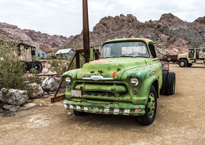 Abandoned car on mountain against sky