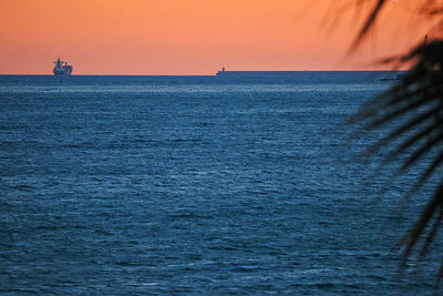 Scenic view of sea against orange sky