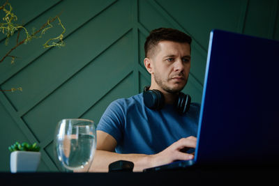 Caucasian man working with laptop at home office workplace. freelancer remote work