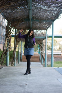 Full length of young woman in park