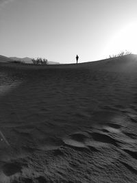 Distant view of person standing at desert in death valley national park
