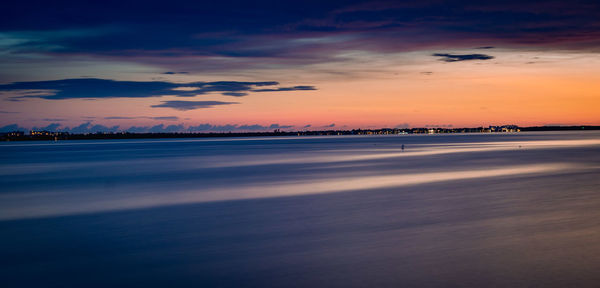 Scenic view of sea against sky at sunset