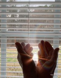 Close-up of hand on glass window