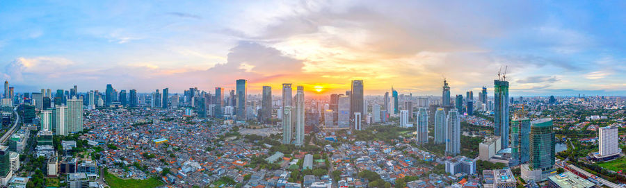 Panoramic view of modern buildings against sky during sunset