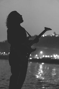 Silhouette man playing guitar