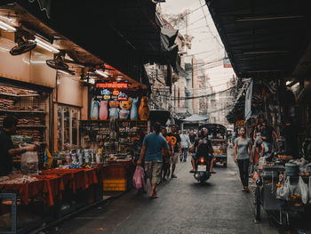 People at market stall in city