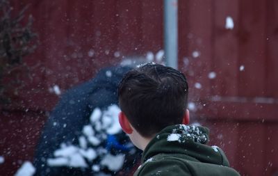 Close-up of boy during snowfall