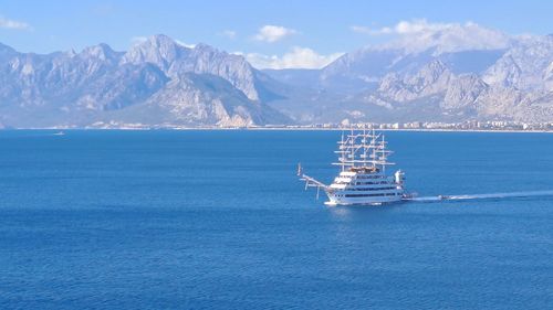 Scenic view of sea and mountains against sky