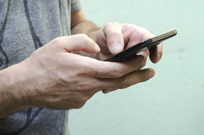 Close-up of man using mobile phone