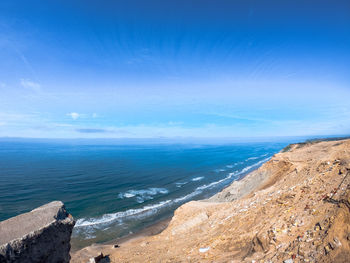 Scenic view of sea against blue sky