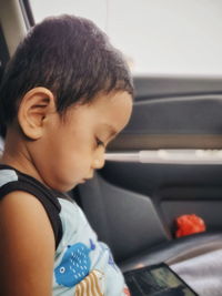 Close-up of boy looking at camera
