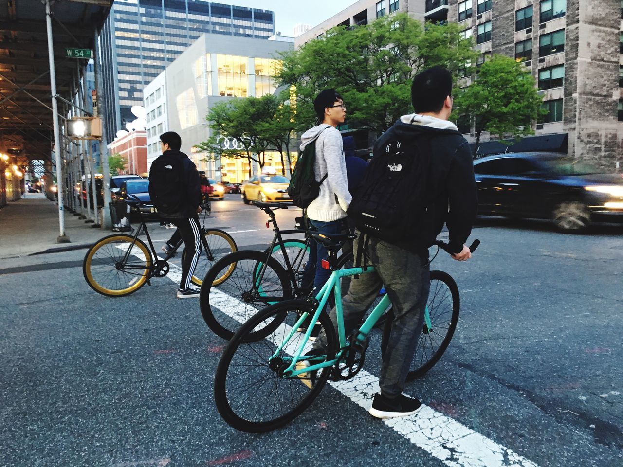 bicycle, transportation, land vehicle, mode of transport, riding, street, building exterior, men, city, full length, lifestyles, architecture, city life, built structure, walking, road, rear view, cycling