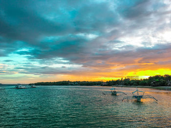 Scenic view of lake against dramatic sky