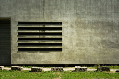 Close-up of pipes on field against wall