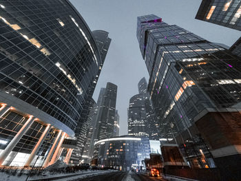 Low angle view of buildings in city at night