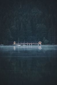 Built structure in lake against trees