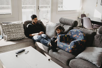 Father with daughter on sofa