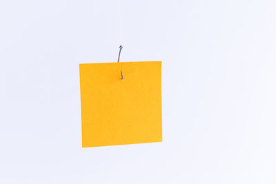 Close-up of yellow paper against white background