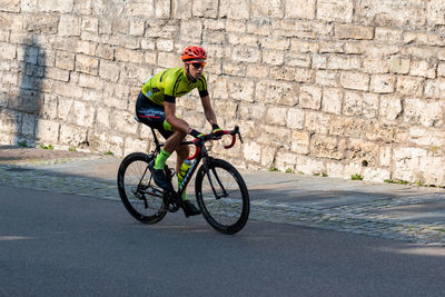 Man riding bicycle on road