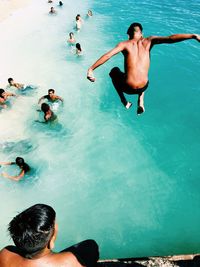 High angle view of men swimming in pool