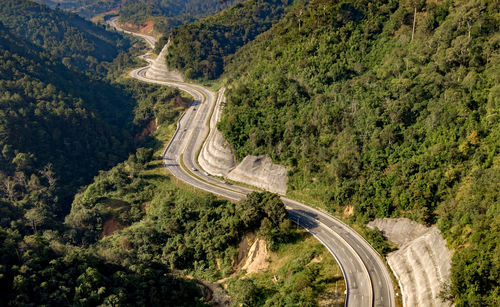 High angle view of vehicles on road amidst trees in forest