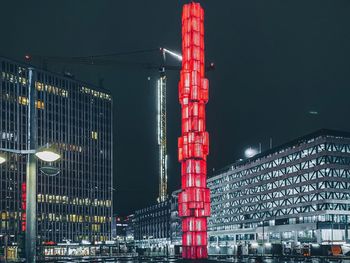 Low angle view of illuminated buildings against sky at night