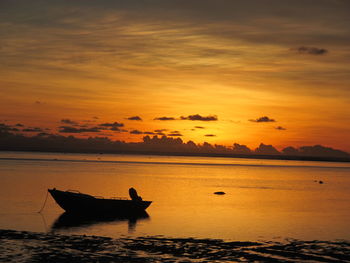 Boat sailing in sea at sunset