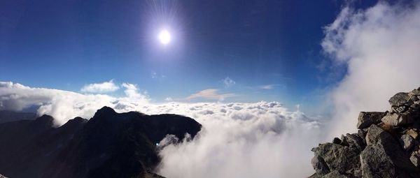 Scenic view of mountains against cloudy sky