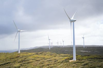 Windmill on field against sky