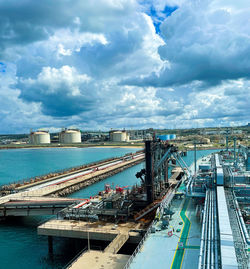 Lpg cargo ship docked in the port. view from the deck of the ship to the shore and gas tanks. 