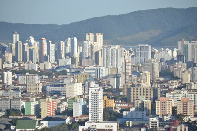 Aerial view of buildings in city against sky