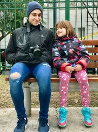 Full length of woman sitting outdoors